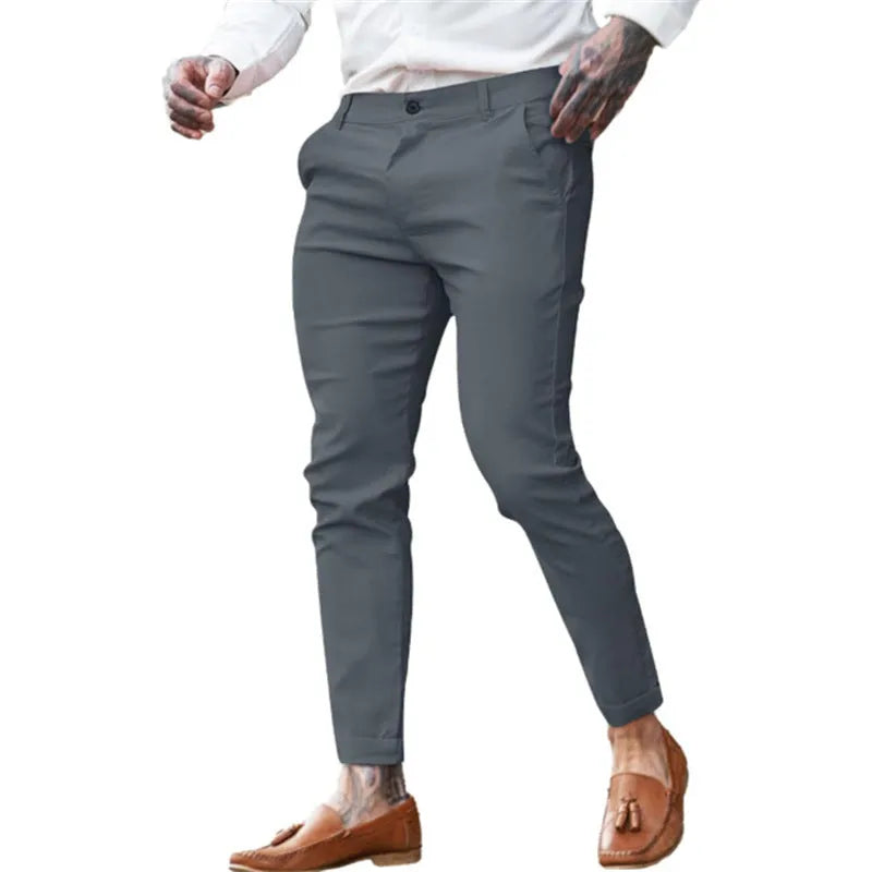 Men's slim-fit pencil trousers in high elasticity cotton twill fabric on a grey background.