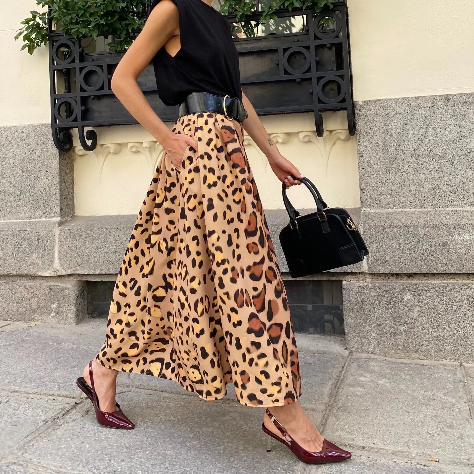 Brown leopard print women's long A-line skirt on a hanger.