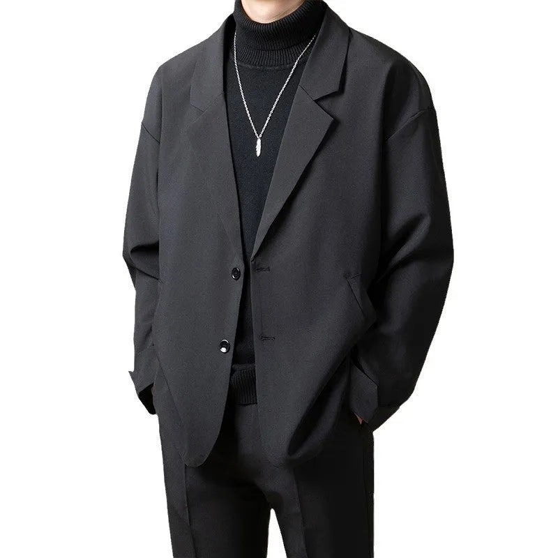 Man wearing a loose fit casual suit jacket in apricot colour, suitable for light business settings.