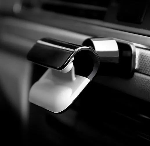 Black universal car phone holder with 360-degree rotation mounted on vehicle air vent
