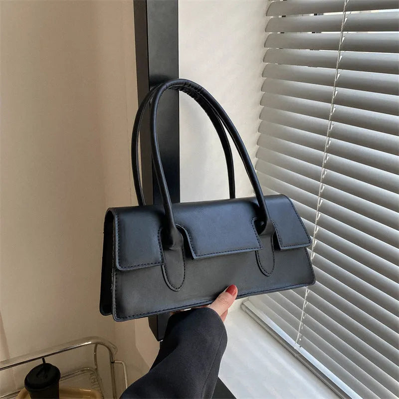 Women's small square shoulder bag in PU material showing stitching details and horizontal shape