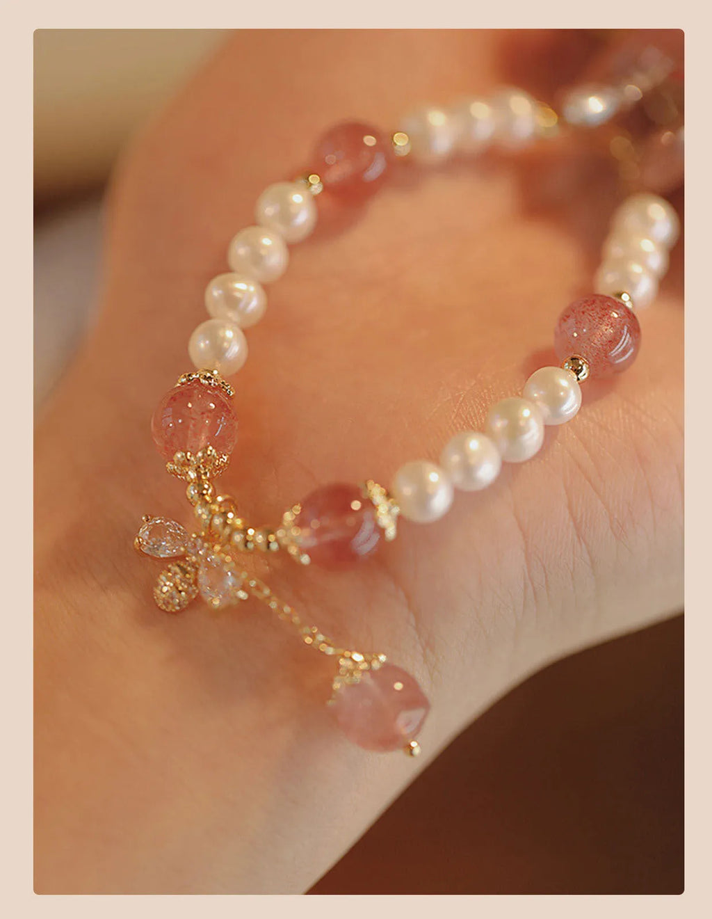 Women's handmade strawberry quartz crystal bracelet with stringed pearls and bow decoration