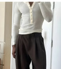 Cream coloured ribbed cotton blend men's henley top with long sleeves and button placket.