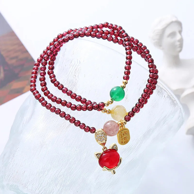 Purplish red garnet fox bracelet with adjustable rope closure and nature-inspired charm