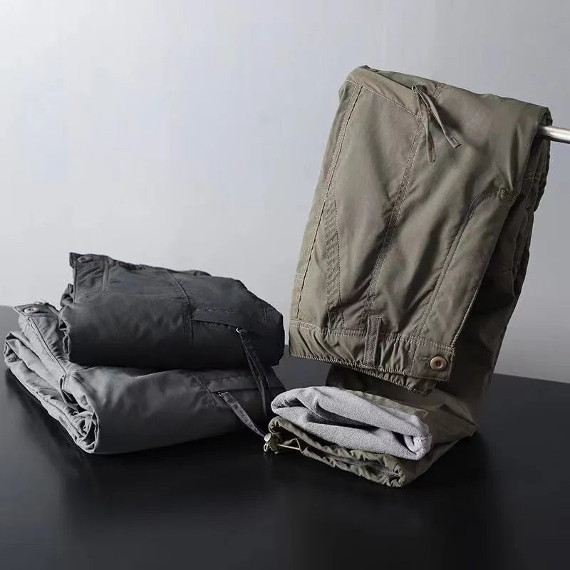 Man wearing thickened warm windproof waterproof fleece lined cotton trousers in army green with belt and double-layer waistband
