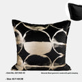 Black and gold abstract patterned flannel decorative cushion on a grey sofa.