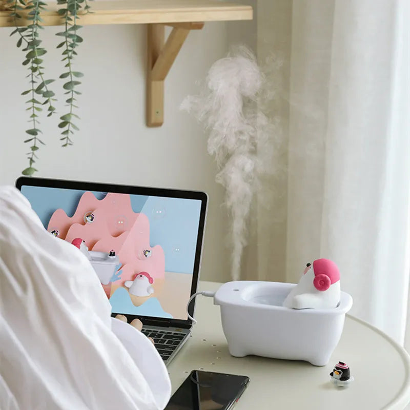 White USB air humidifier with large water tank on a desk.