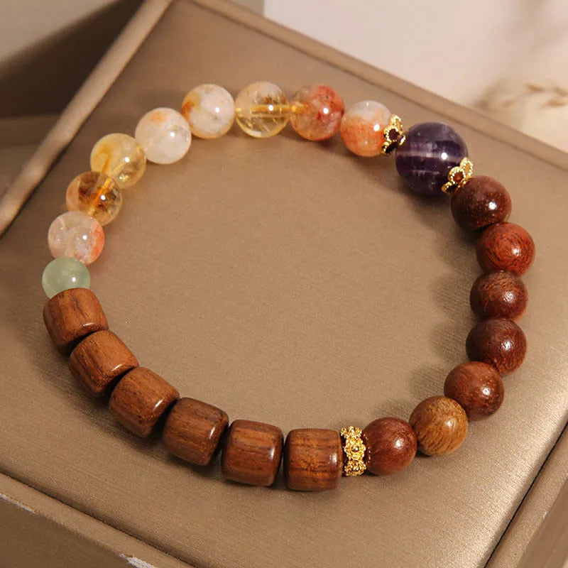 Women's bracelet with yellow crystal, amethyst, ebony, pearls, and rhinestones.