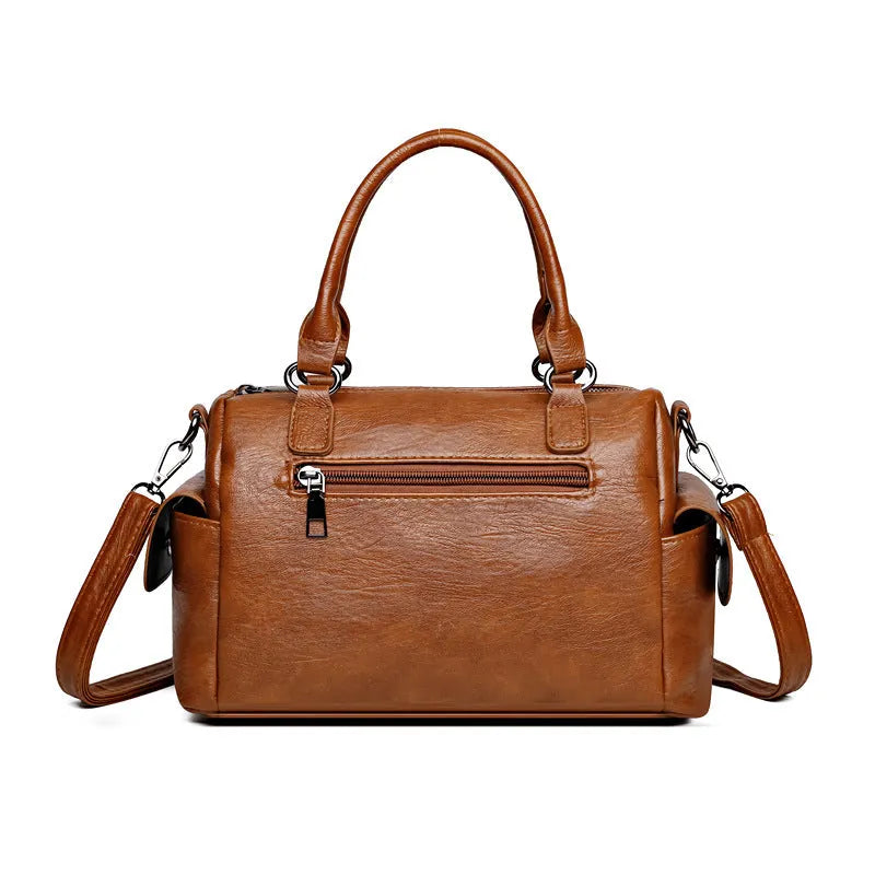 Vintage style square messenger bag in PU leather with visible stitching, shown in multiple colour options.