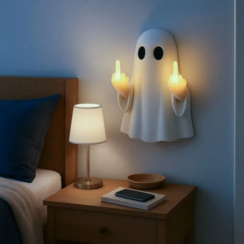 Small white ghost-shaped plastic night lamp for Halloween decoration on a table.
