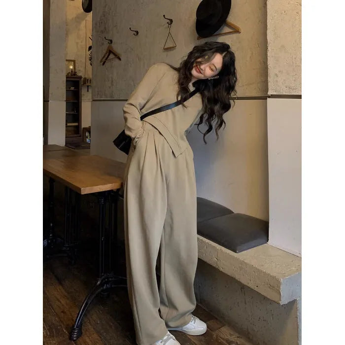 Women's khaki casual sports suit set with long sleeve top and matching trousers on a hanger.