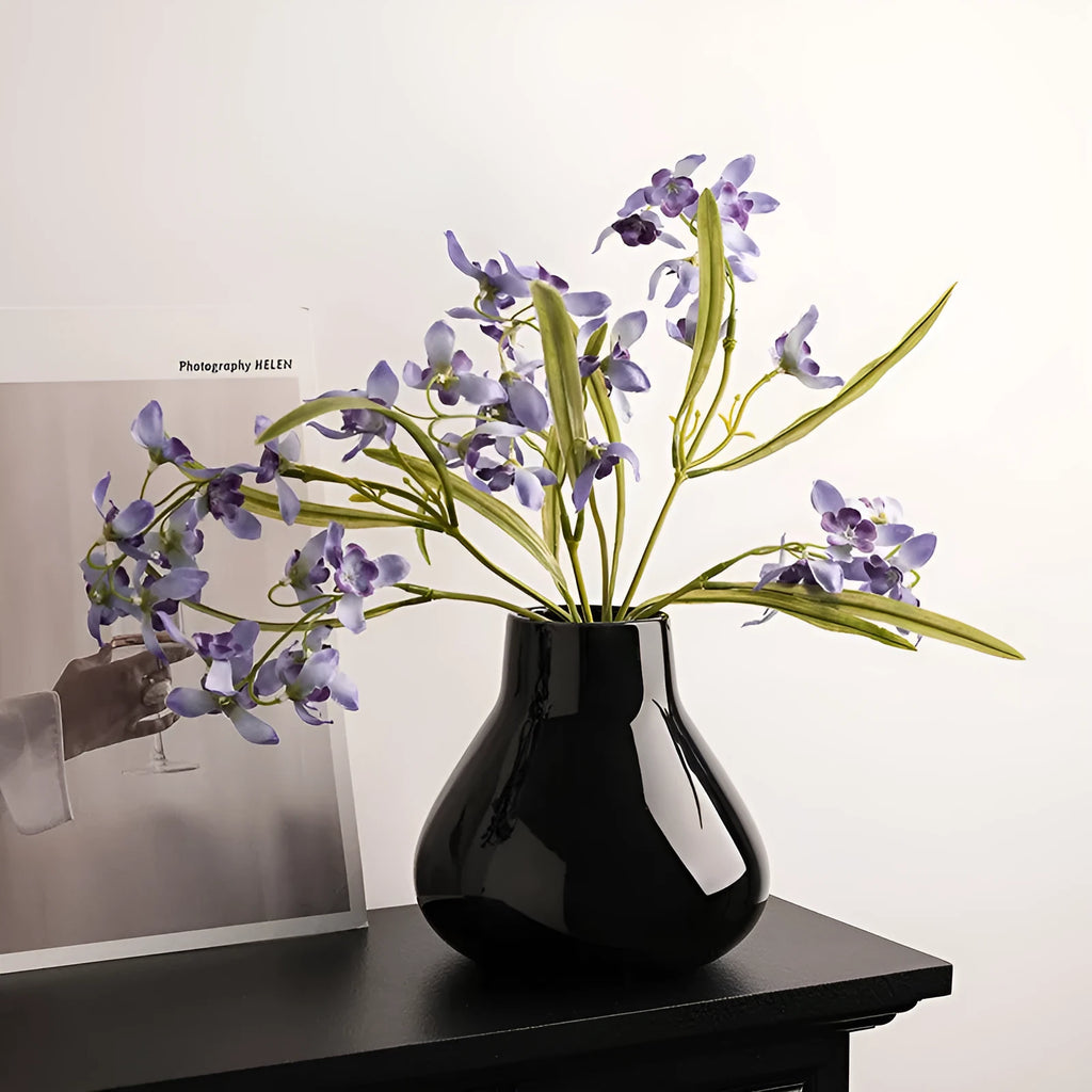 Ceramic round belly decorative vase with coloured glaze and artificial flowers in black or white