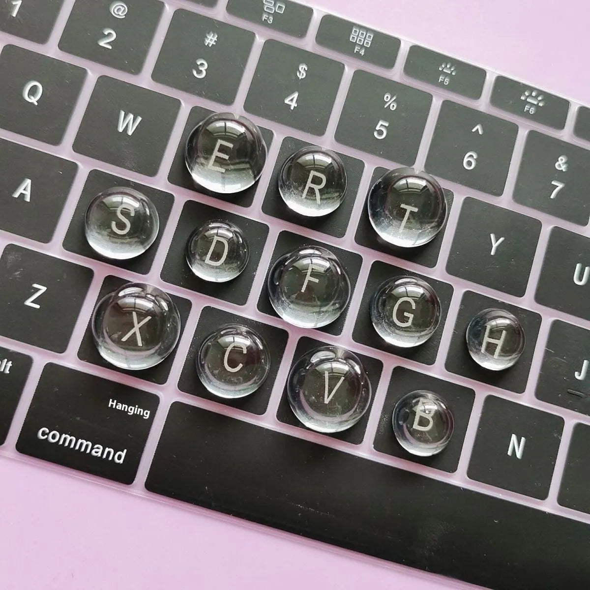 Set of PVC crystal glass ball keyboard stickers in 12x6mm size on a keyboard showing raised transparent domes
