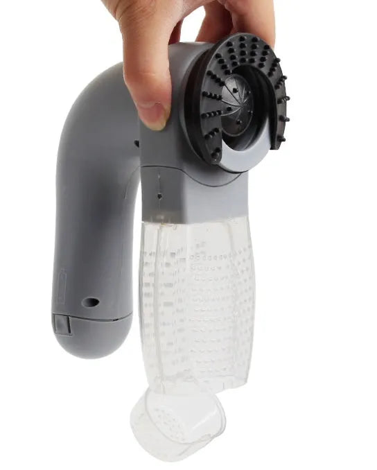 Grey handheld pet hair vacuum cleaner with soft rubber brush head for grooming dogs and cats.