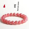 Women's geometric rhodochrosite crystal bracelet with a longevity lock clasp on a wrist.
