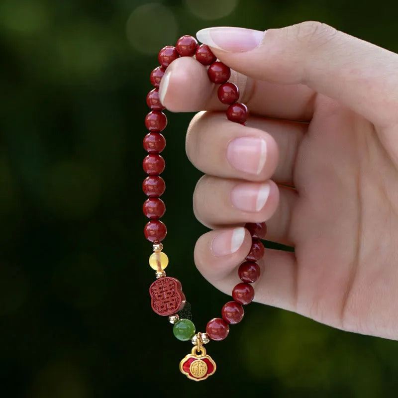 Happy Eyebrow bracelet made of raw Emperor Sandstone beads with a red Cinnabar and fu character charm.