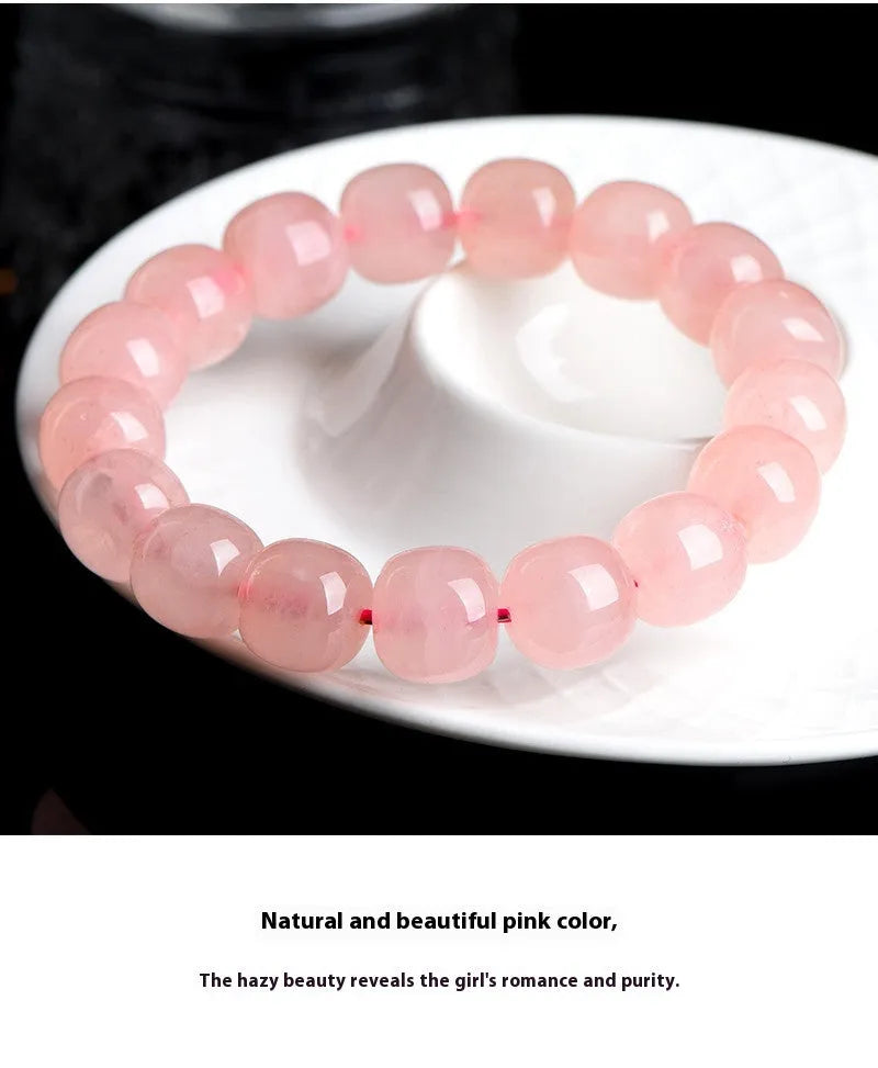 Pink natural crystal barrel bead bracelet with geometric shapes measuring 8-10mm