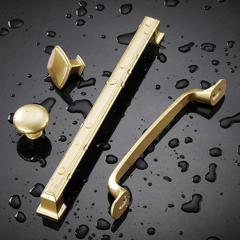 Gold aluminium alloy T-shaped open cover cabinet drawer pull handle for single-hole mounting.