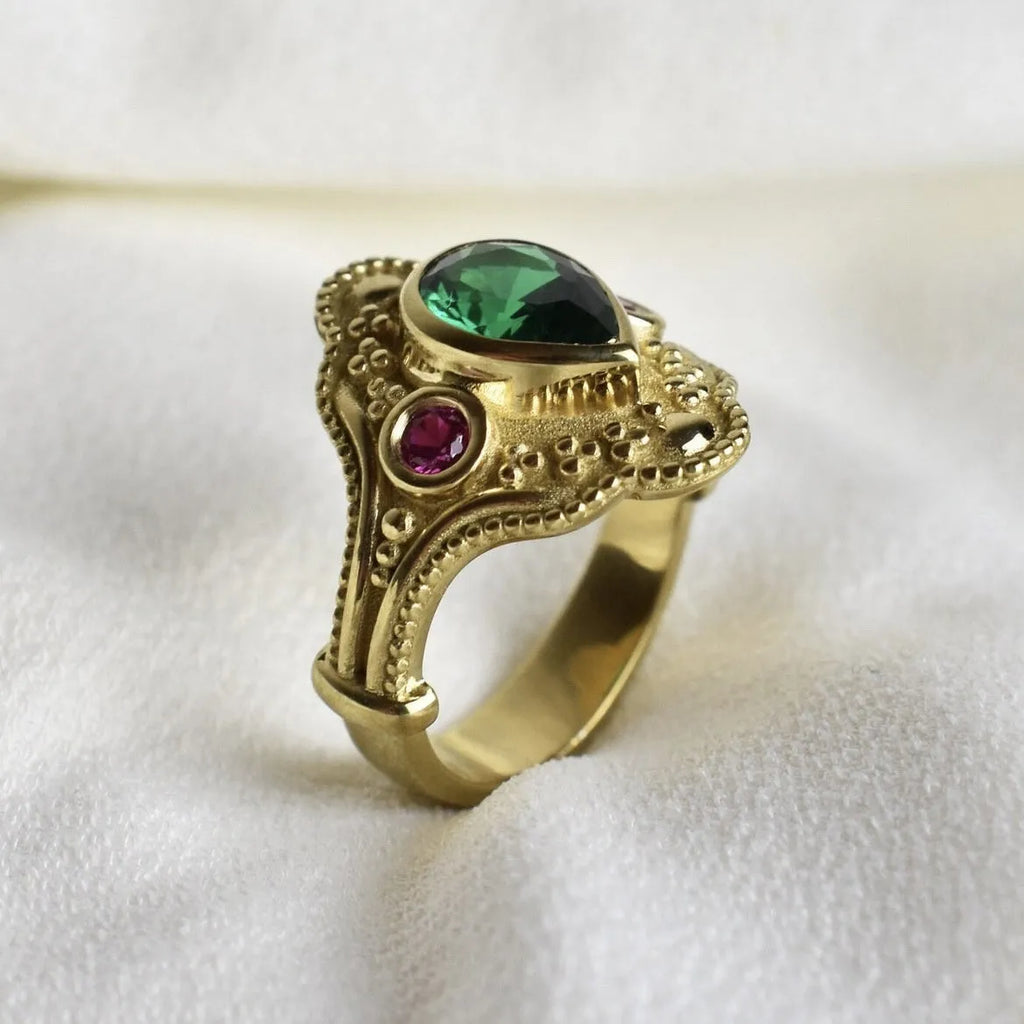 Golden geometric women's ring on a plain background, showing its alloy construction and electroplated finish.
