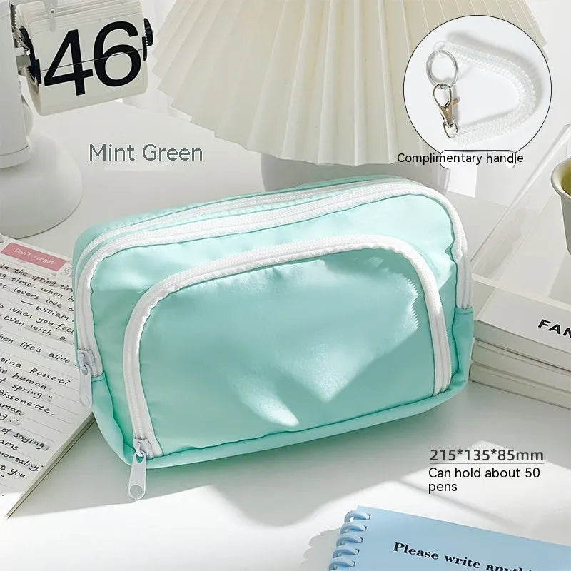 Double layer zippered pencil case in blue, cream, green, or pink with a gift handle