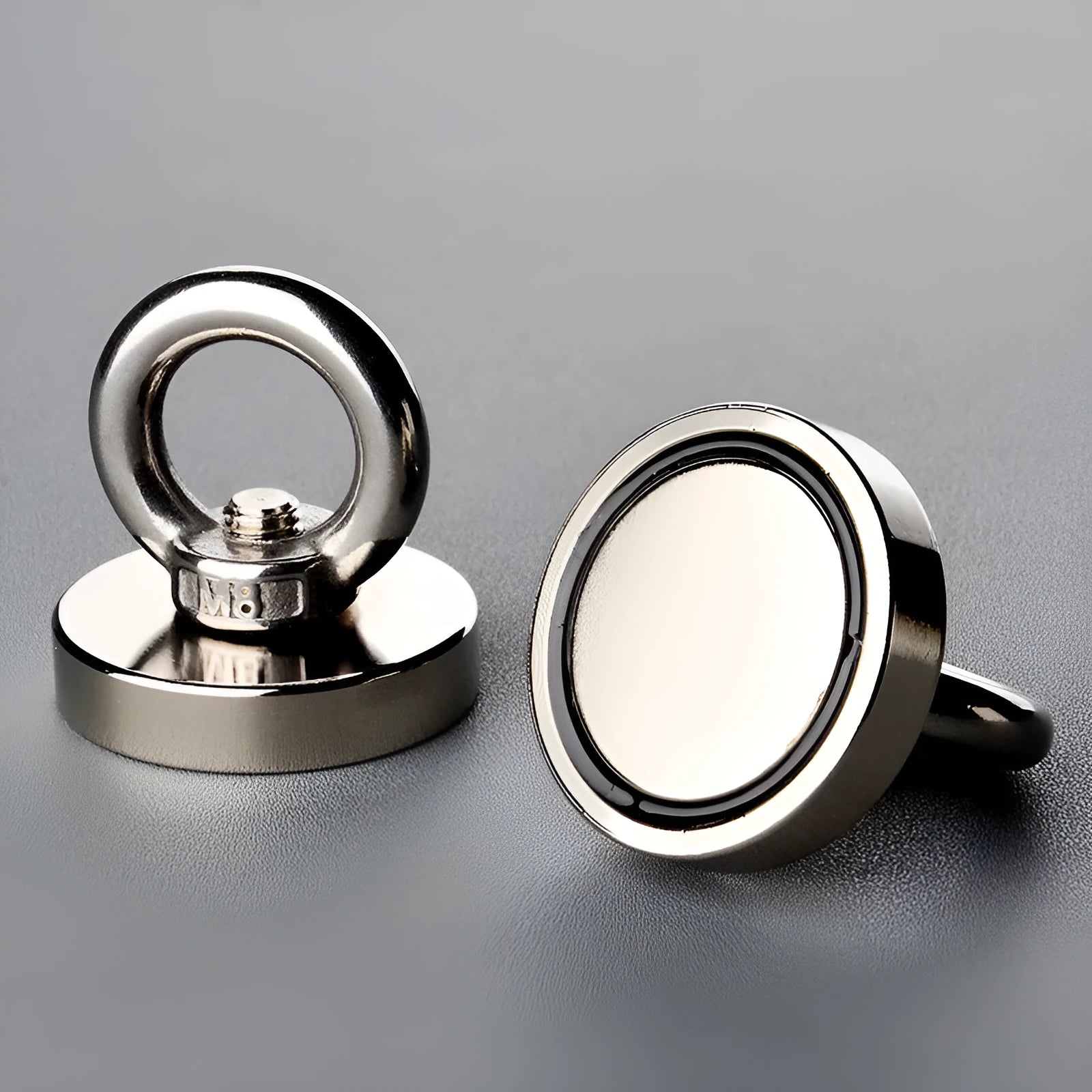 Round 60mm NdFeB salvage magnet with black coating, attached to a rope and metal ring