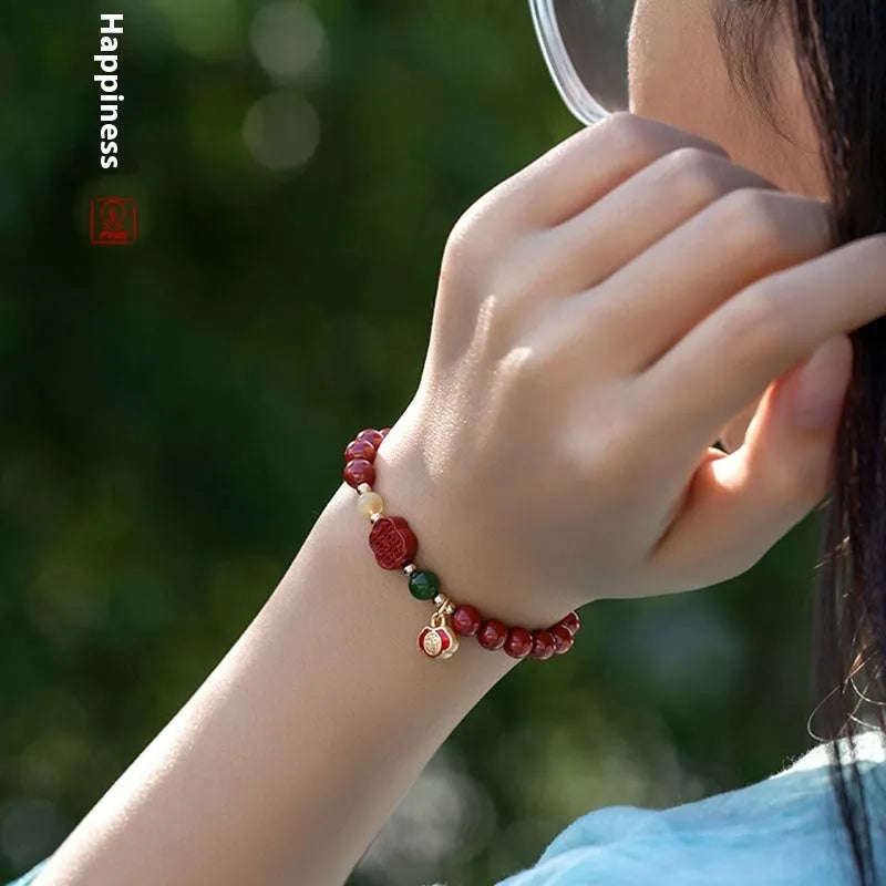 Happy Eyebrow bracelet made of raw Emperor Sandstone beads with a red Cinnabar and fu character charm.