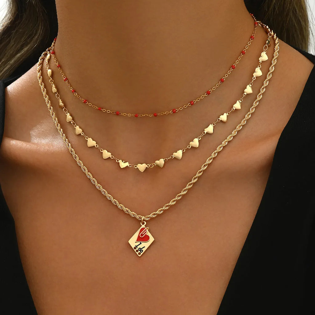 Adjustable three-layer zinc alloy clavicle chain necklace with a geometric heart pendant.