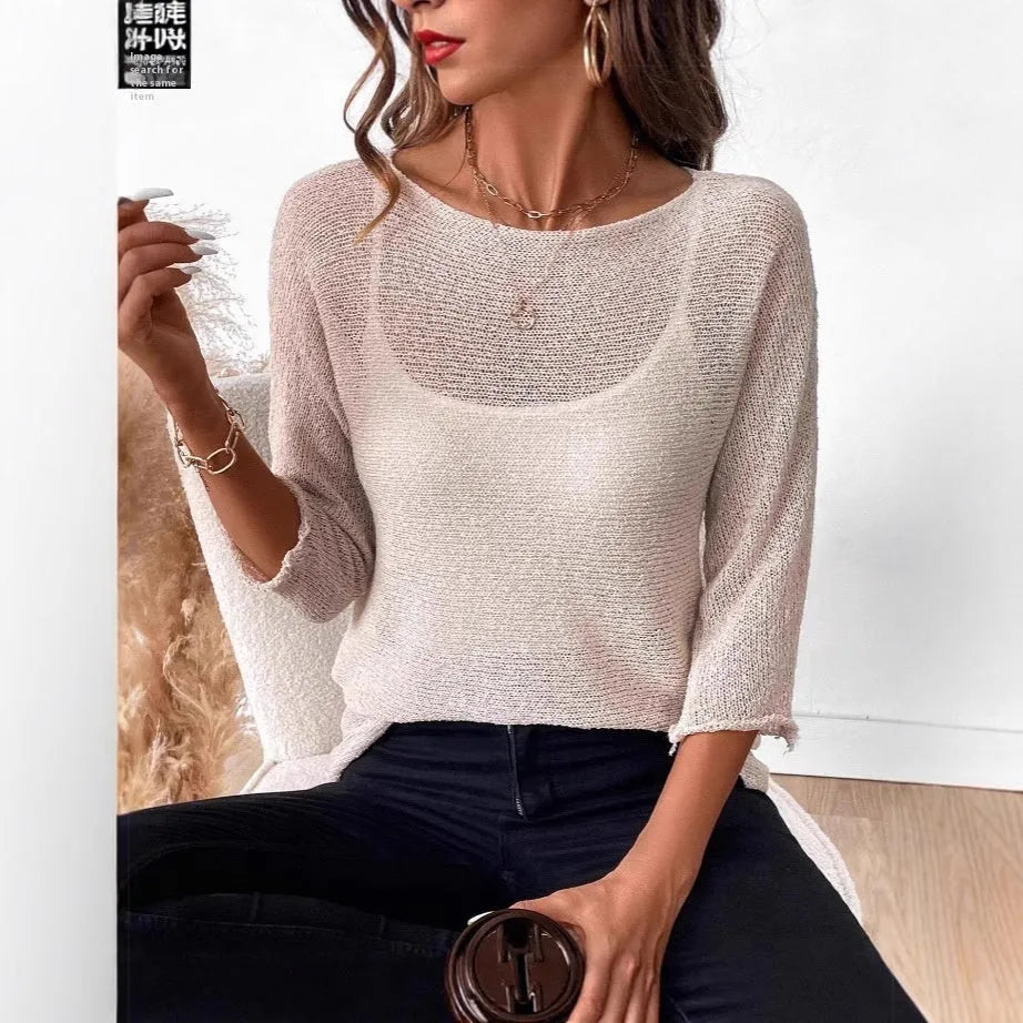 Woman wearing a thin knitted off-shoulder overall with a 3D pattern in a light colour.