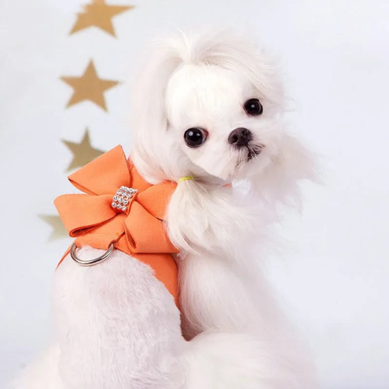 Cute pink microfiber dog chest strap harness with a large bowknot decoration and a metal D-ring.
