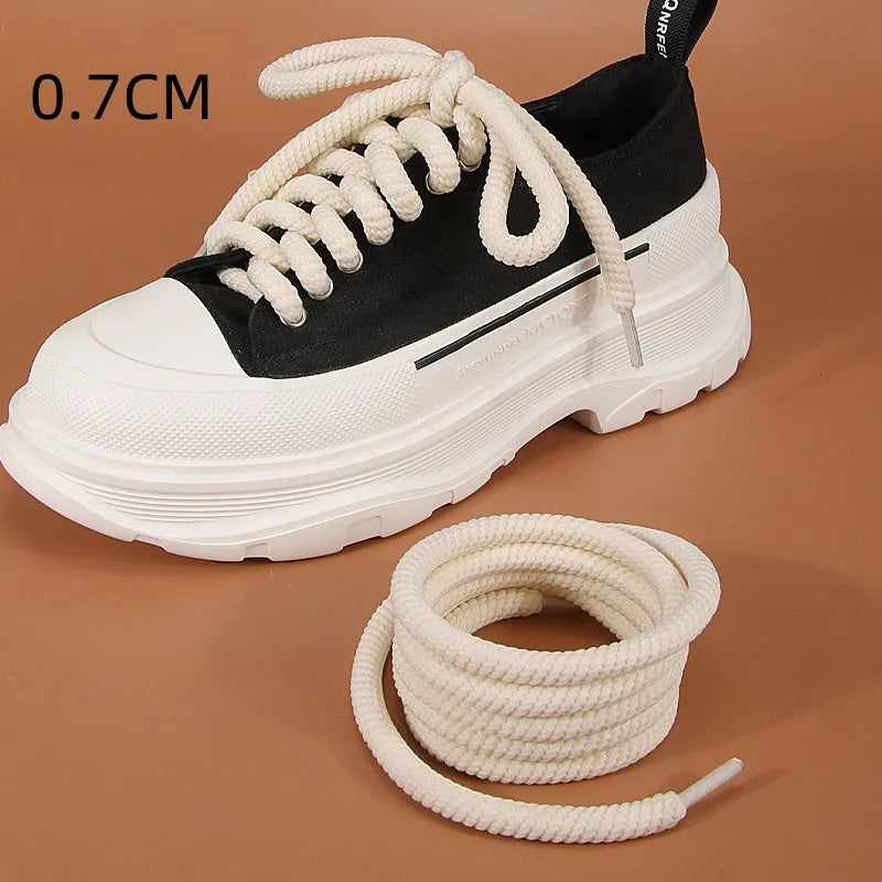 Round white woven shoelace on a grey background showing its 10mm diameter and textured weave.