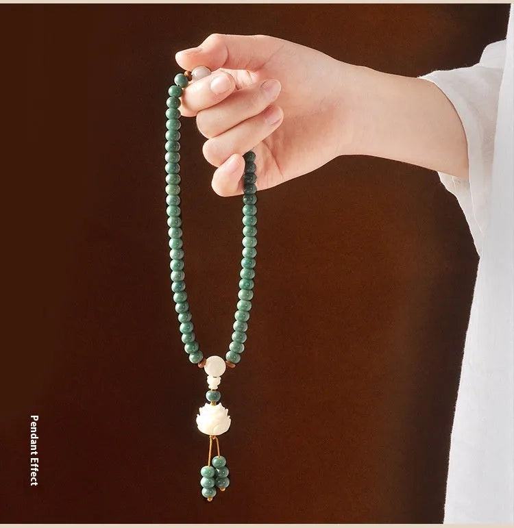 White jade and green sandalwood Bodhi seed bracelet with double ring safety buckle and lotus design.