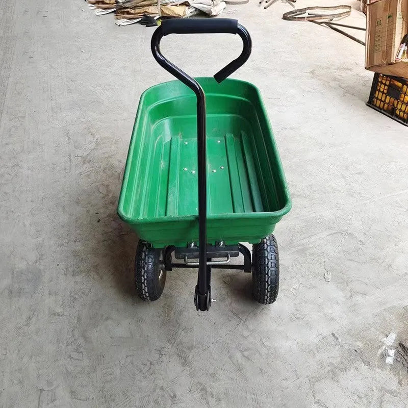 Green four-wheel plastic dump truck with steel reinforcement and dump mechanism for agricultural material transport
