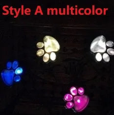 Set of four black solar-powered bear paw print LED garden lights with central solar panel pole.