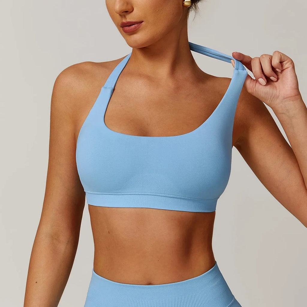 Women's halter style yoga sports bra in nylon fabric with removable padding