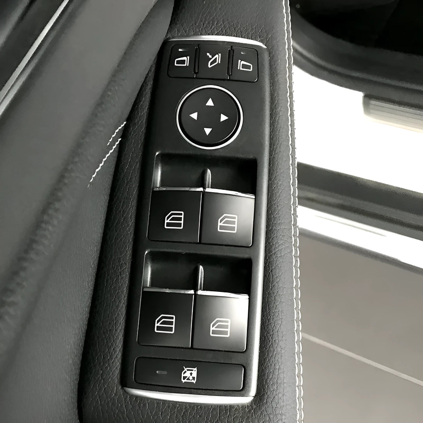 Black glitter decorative sticker for car window lift button modification on a dark background.