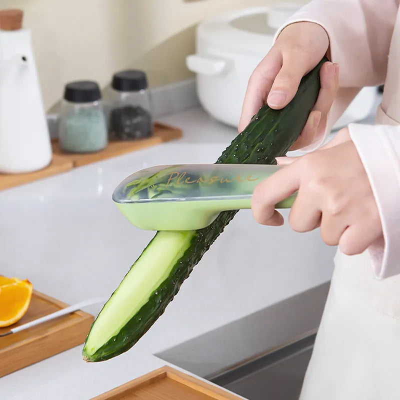 Dark green kitchen peeler with storage tube and stainless steel blade for peeling vegetables and fruit