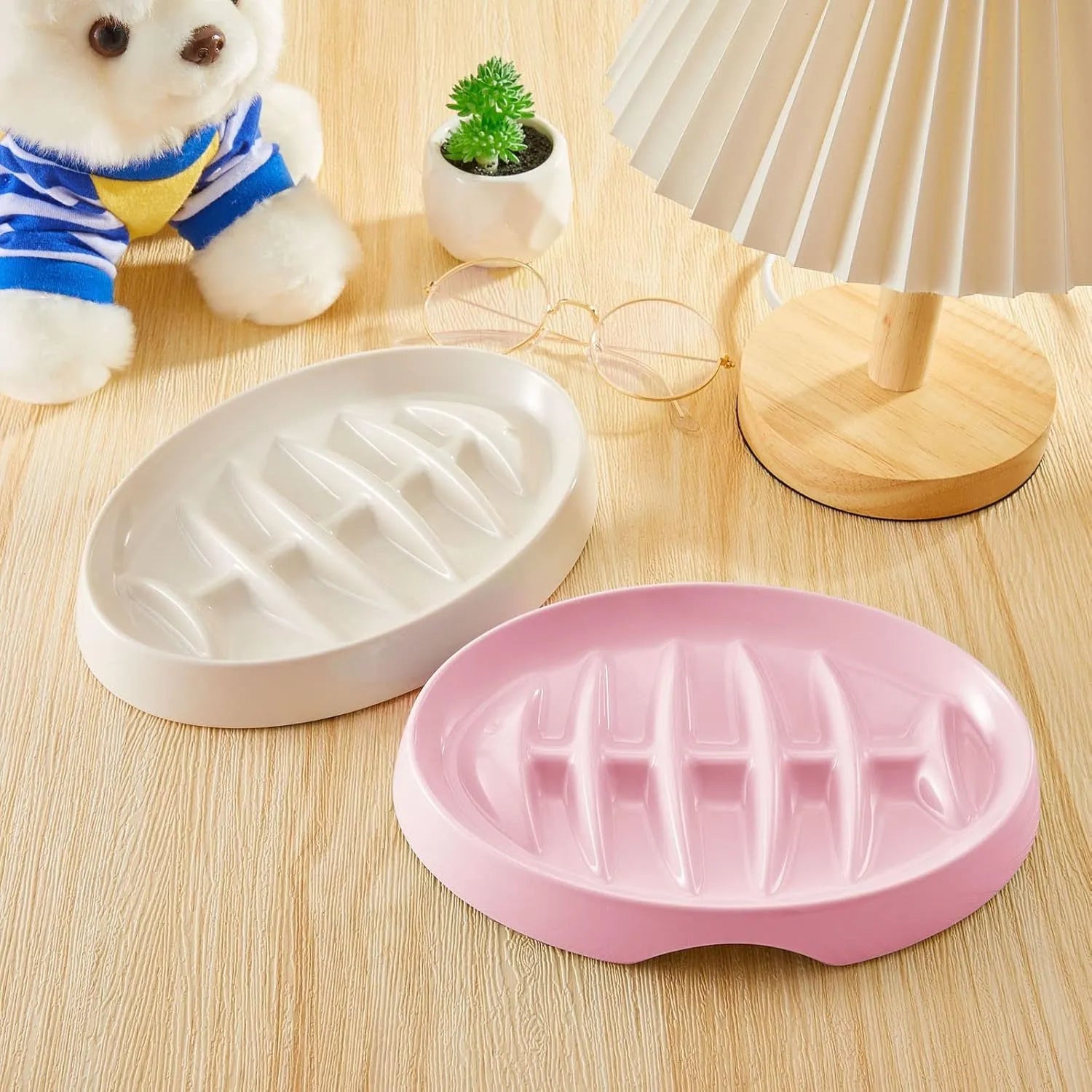 Green melamine fishbone slow feeder bowl for cats with raised ridges on a plain background