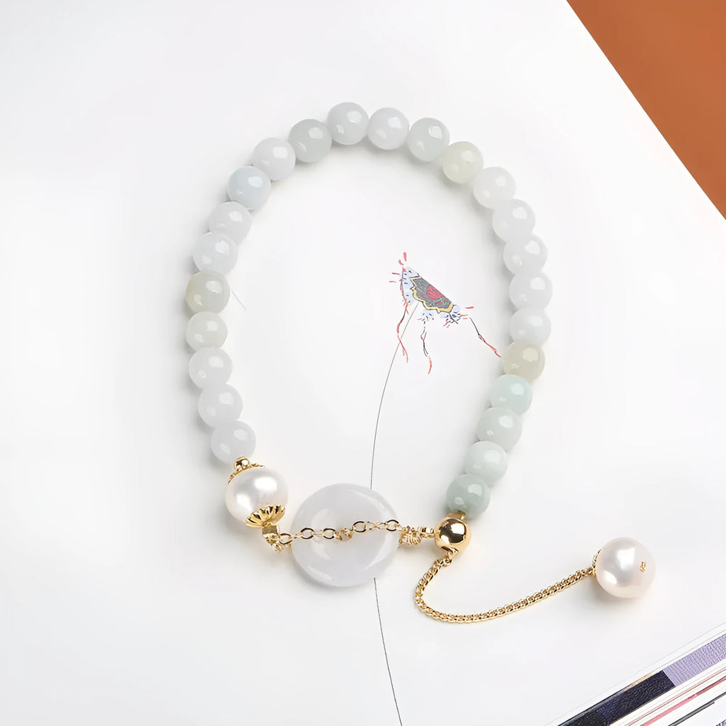 Natural emerald green jade round pendant on a women's bracelet with a geometric peace buckle.