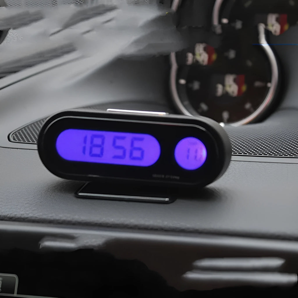 Black car dashboard clock thermometer with luminous LED display showing time and temperature