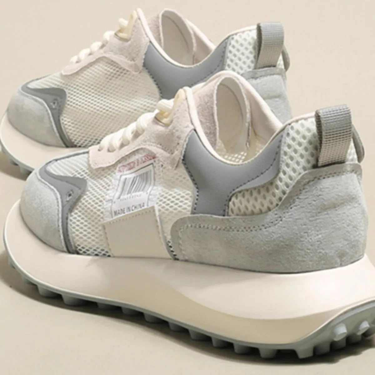 Women's low-top retro sneaker in grey with round toe, rubber sole, and shallow-cut design under 7cm.