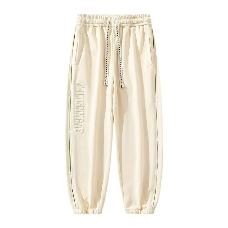 Men's loose fit cotton trousers with banded ankle and collage stitching detail in grey green