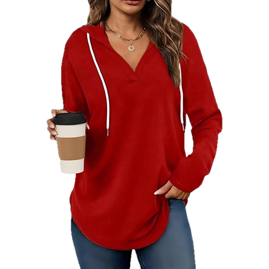 Women's red V-neck sweatshirt with hood and long sleeves showing loose fit design