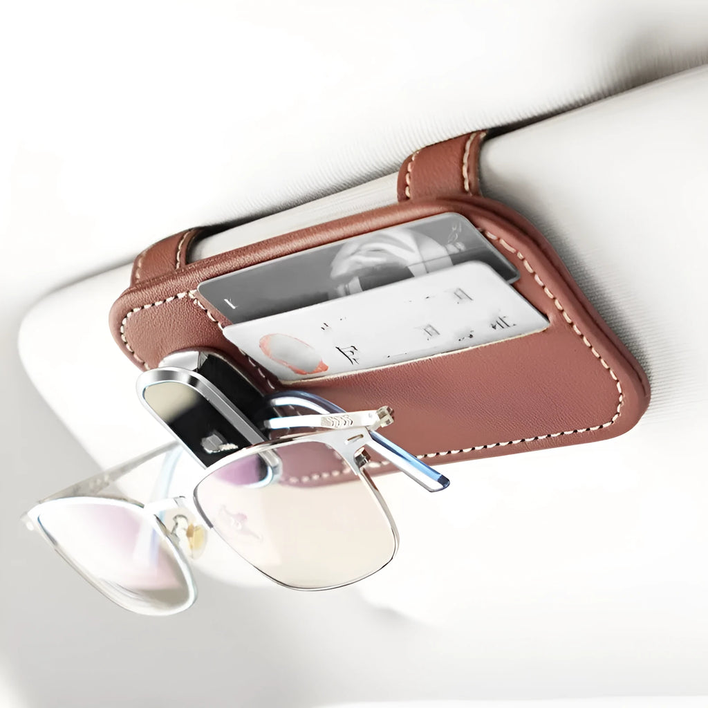 Beige first-layer cowhide leather card holder snapped onto a car's sun louver.