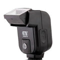 Silver hot shoe flash unit tilted on SLR camera showing aluminium construction and compact 65x60x98mm dimensions