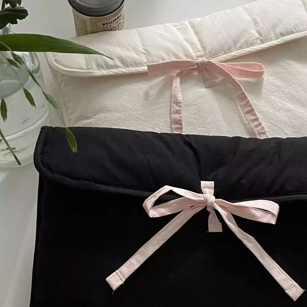 Women's black quilted laptop bag with ballet bow and striped pattern, showing 11-inch and 13-14 inch size options