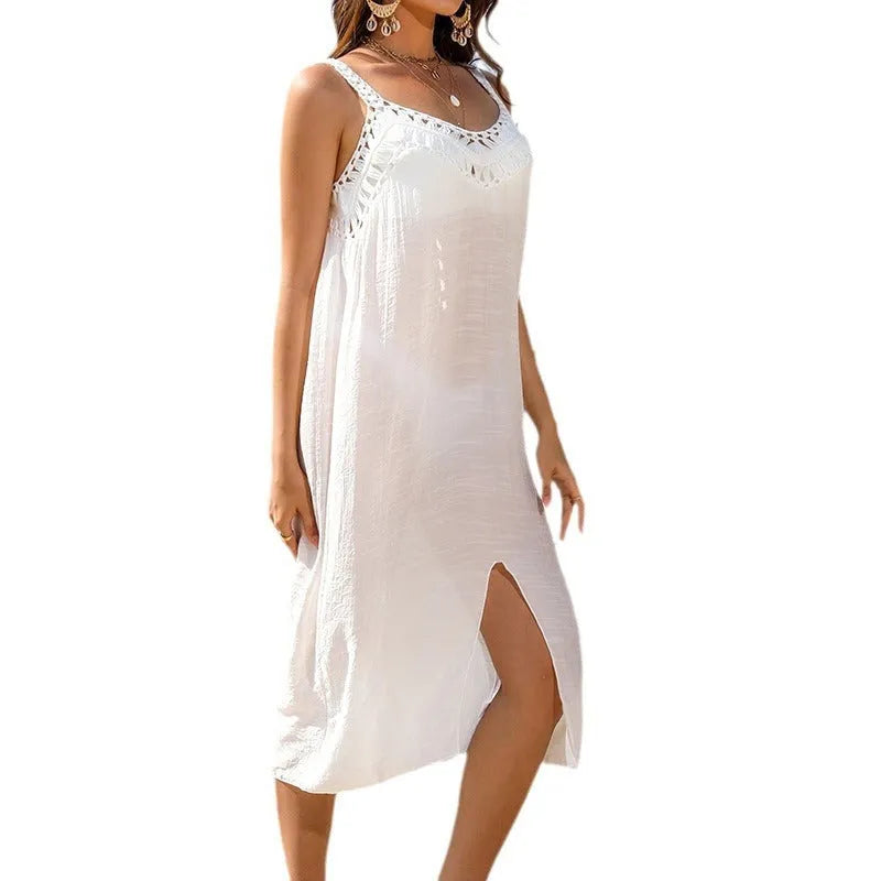 White women's beach dress with hollow crocheted weaving and a bottom slit.