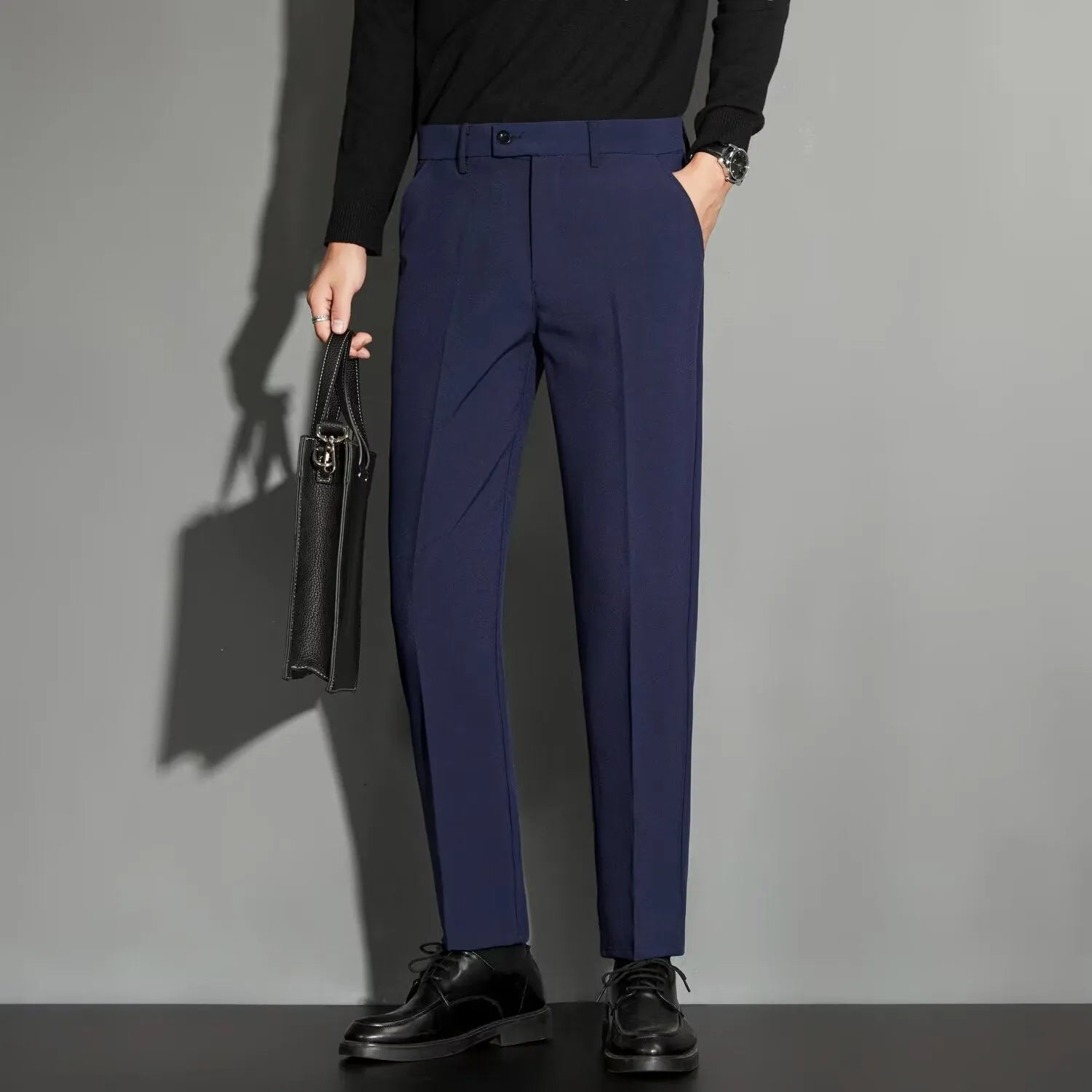 Men's straight-leg ankle-length suit trousers in a chemical fibre blend fabric shown in a classic colour.