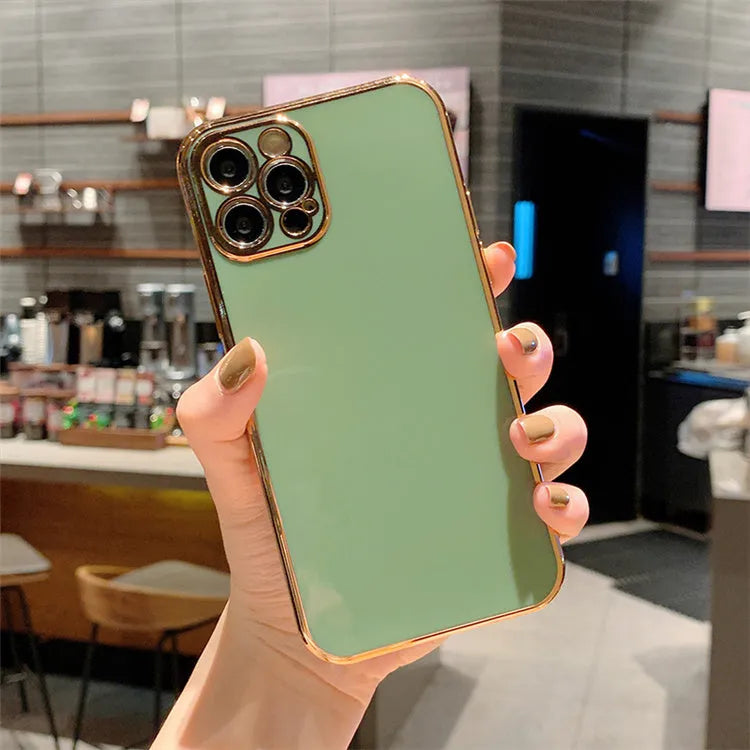 iPhone protective case with a gold metal frame and raised silicone stripes on a coloured TPU back.