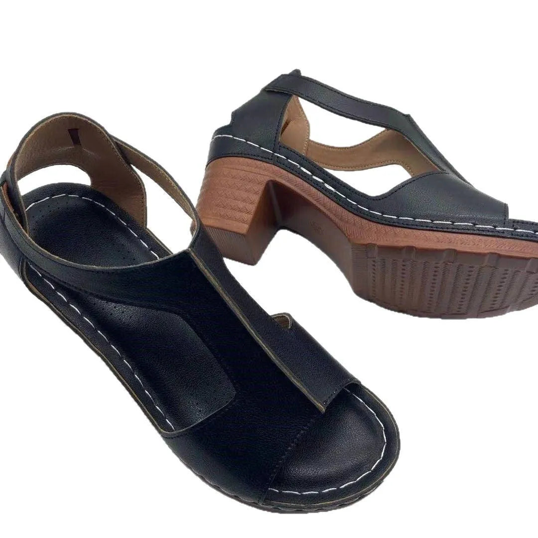 Women's white peep toe wedge sandals with a buckle and low heel on a neutral background.