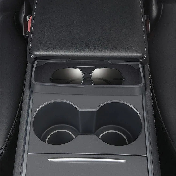 Black silicone sunglasses case mounted in Tesla centre console armrest compartment